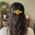 Barrette fleur à perles rouges et jaunes