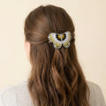 Barrette perlée papillon argentée