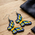 Boucles d'oreilles papillon jaunes perlées