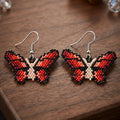 Boucles d'oreilles papillon noires/beiges à perles