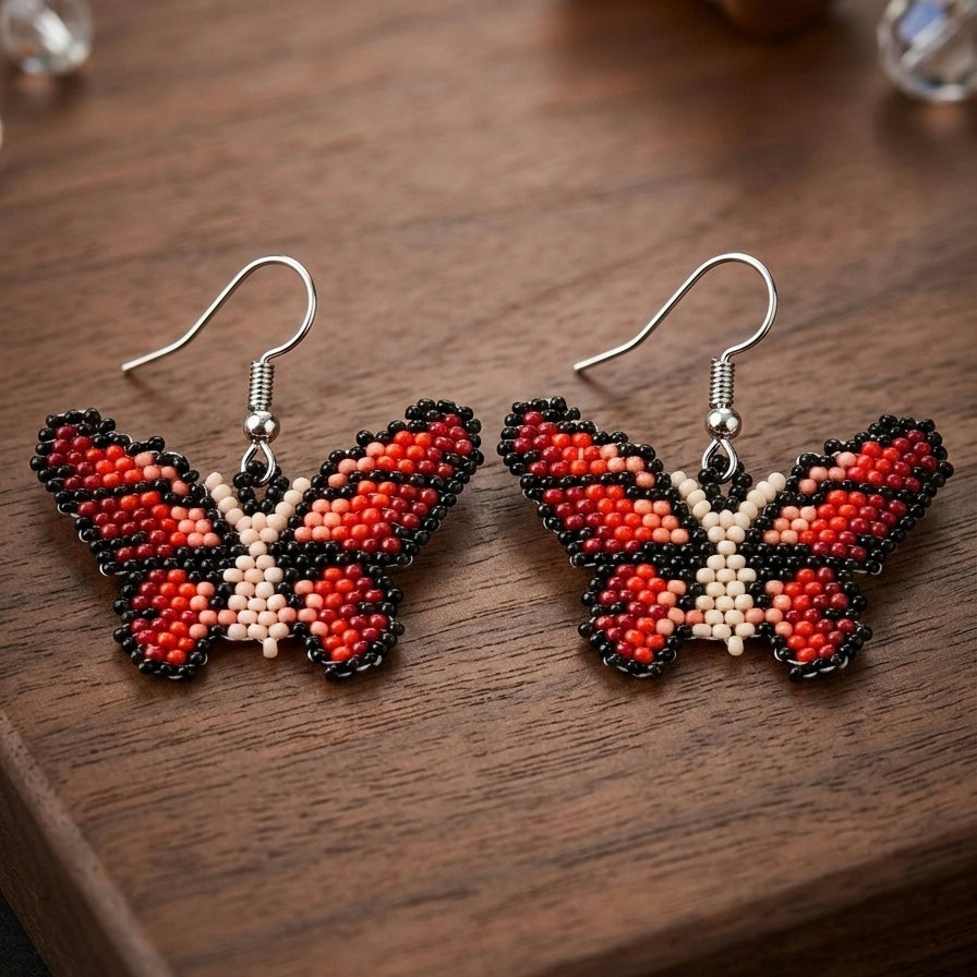 Boucles d'oreilles papillon noires/beiges à perles
