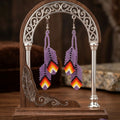 Boucles d'oreilles plume perlée violette OldTribes™