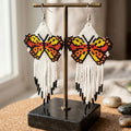 Boucles d'oreilles blanches perlées Ailes de danse