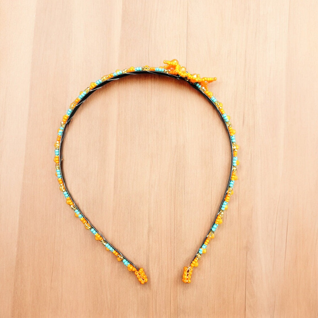 Bandeau perlé avec fleur orange