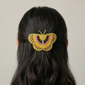 Barrette papillon jaune perlée