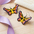 Boucles d'oreilles papillon perlé jaune et violet
