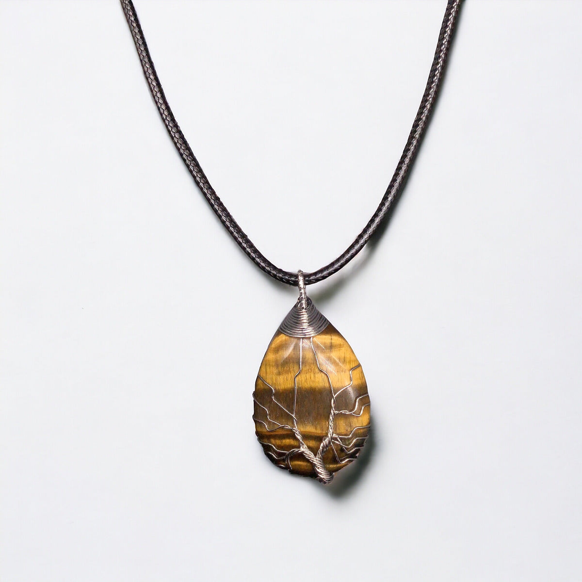Pendentif en pierres précieuses Œil de tigre doré jaune, enveloppé d'un arbre de vie en argent