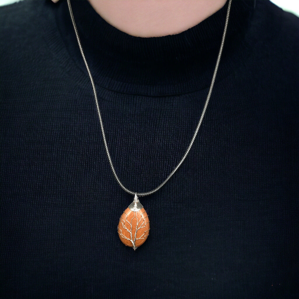 Pendentif gemme orange enveloppé avec arbre de vie argenté