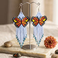Boucles d'oreilles ailes dansantes perlées violet clair