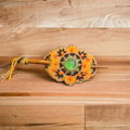 Barrette de style amérindien, avec des accents orange et noirs