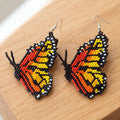 Boucles d'oreilles papillon perlées rouges et blanches